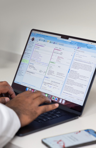 A provider checking Electronic Health Records on a MacBook Pro.