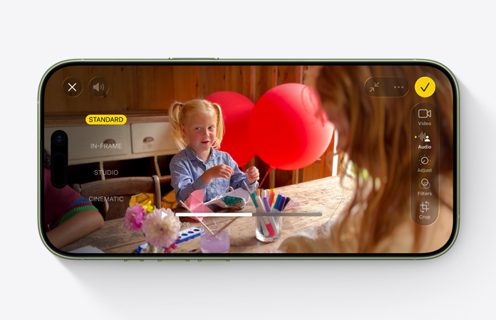 iPhone 17, front exterior, video with Audio Mix feature in use, child playing at a table with balloons
